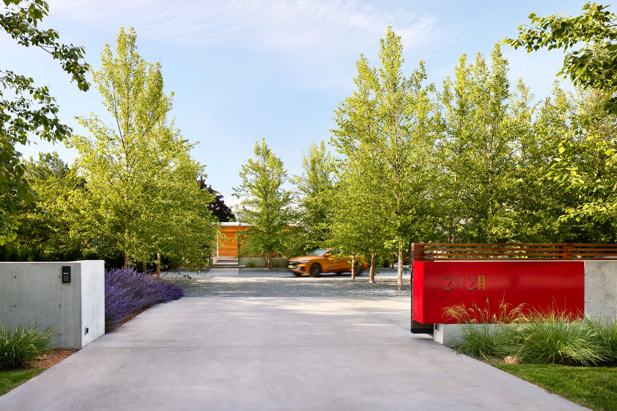 Red Gated Driveway And Entry Landscaping