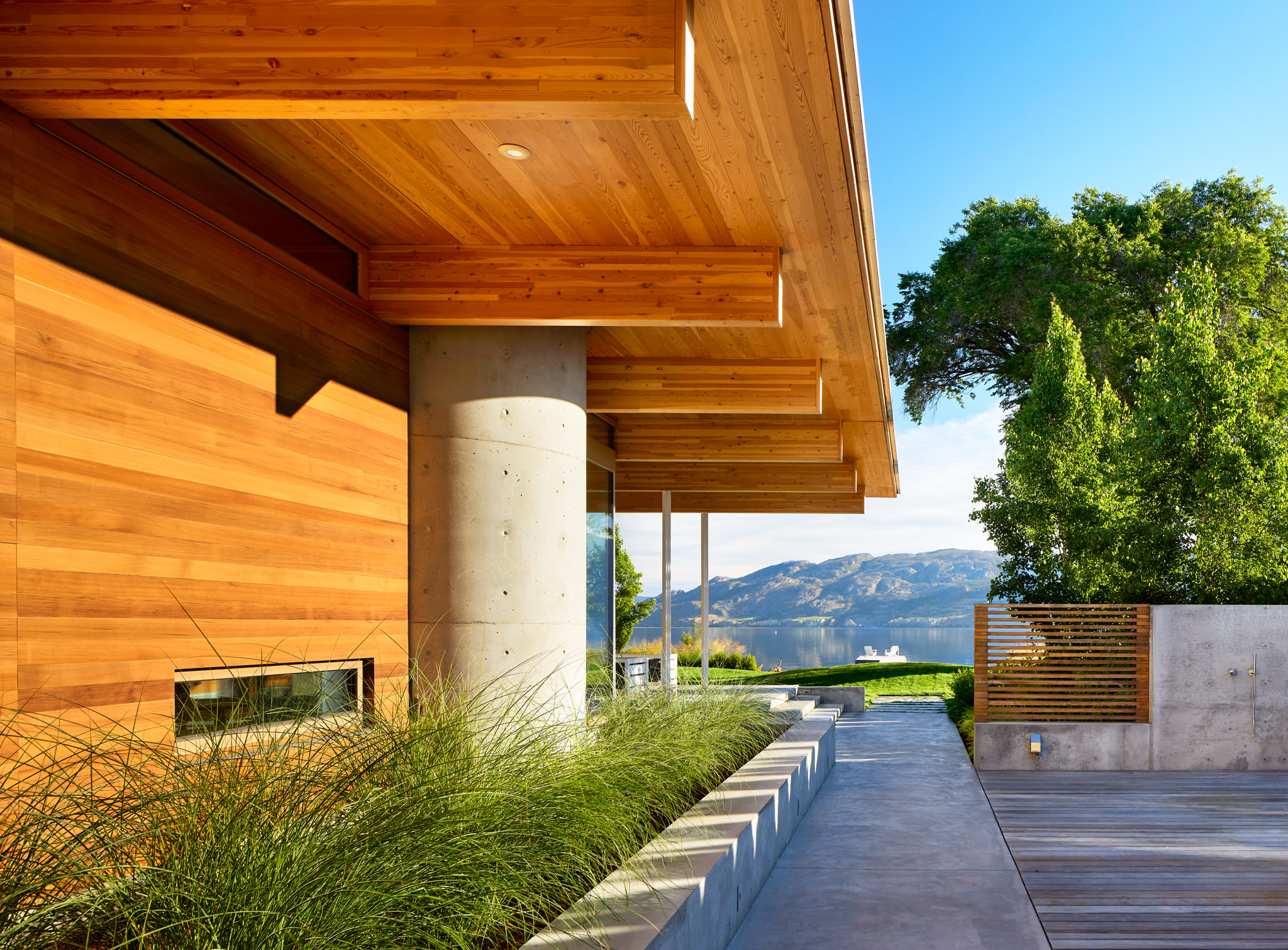 Afternoon Light on Modern Wood Residence With Landscaping And Lake