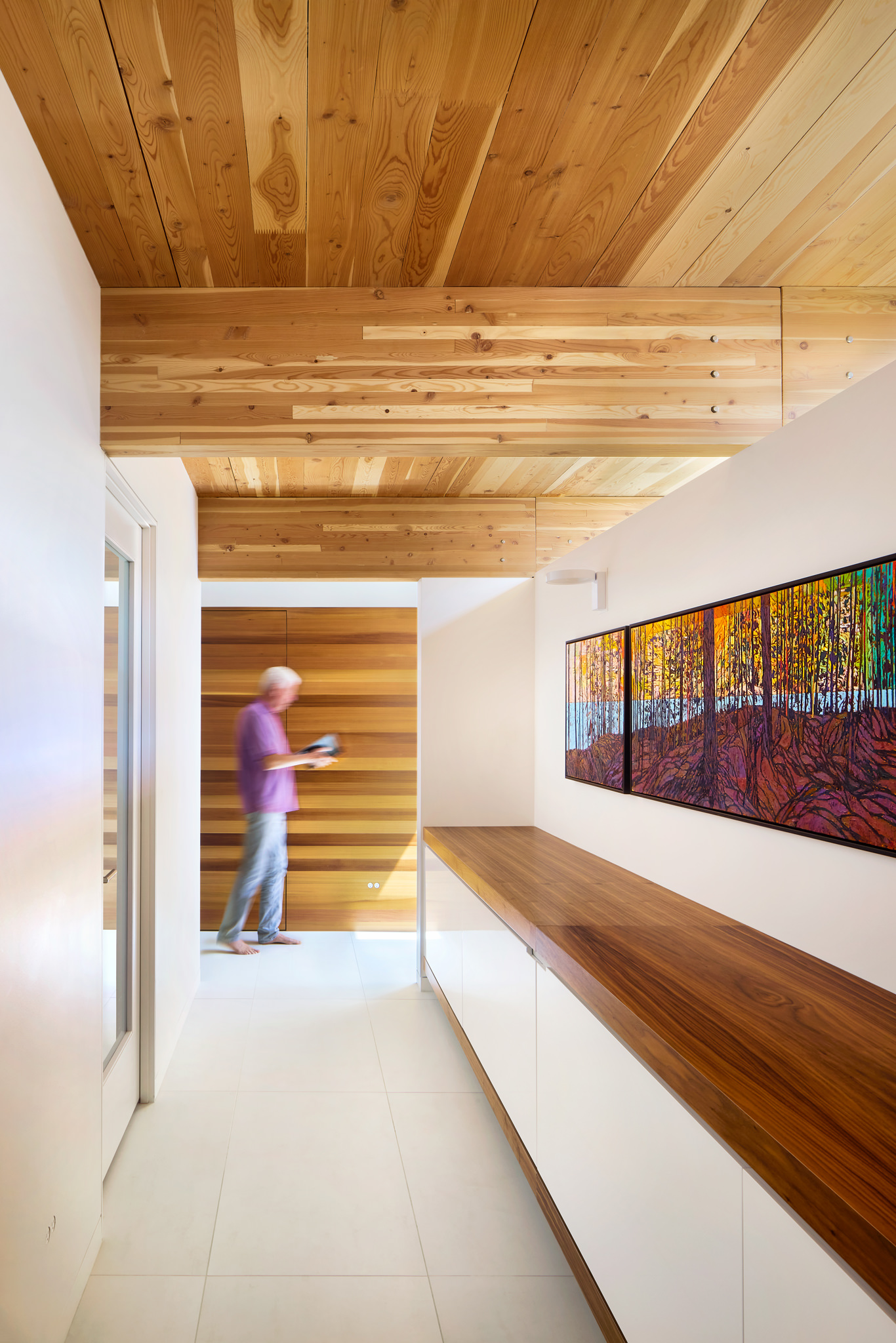 Interior view of bright modern home with wood materials and art