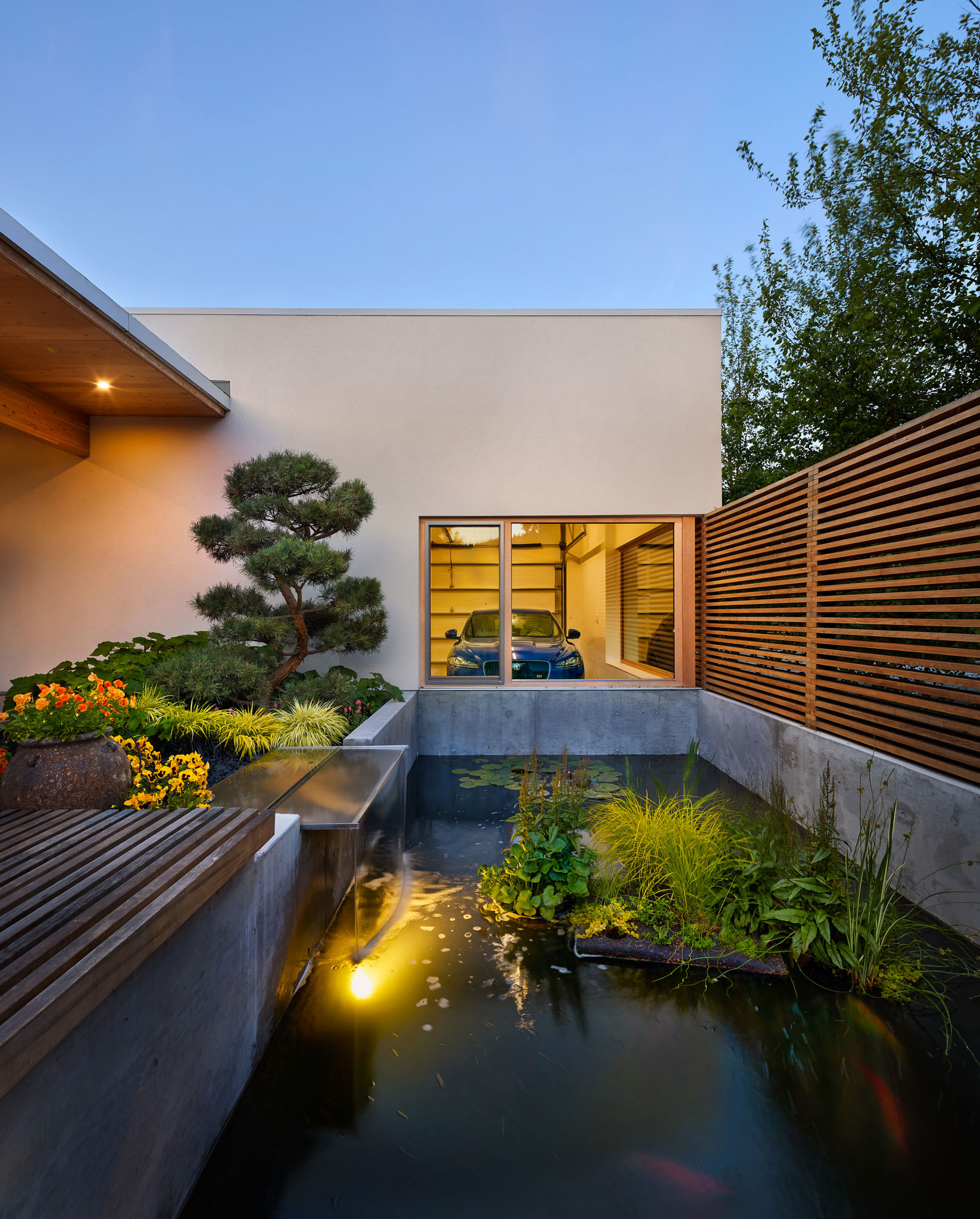 Entry View Of Modern Home With Koi Pond And Garage