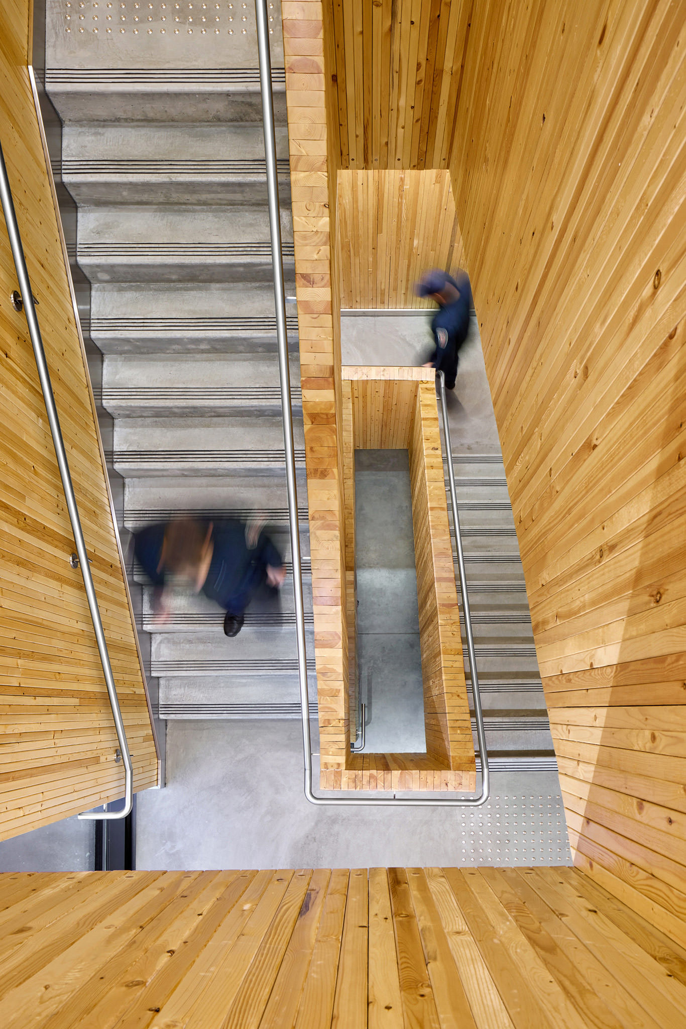 Wood And Concrete Staircase With Firefighters From Above