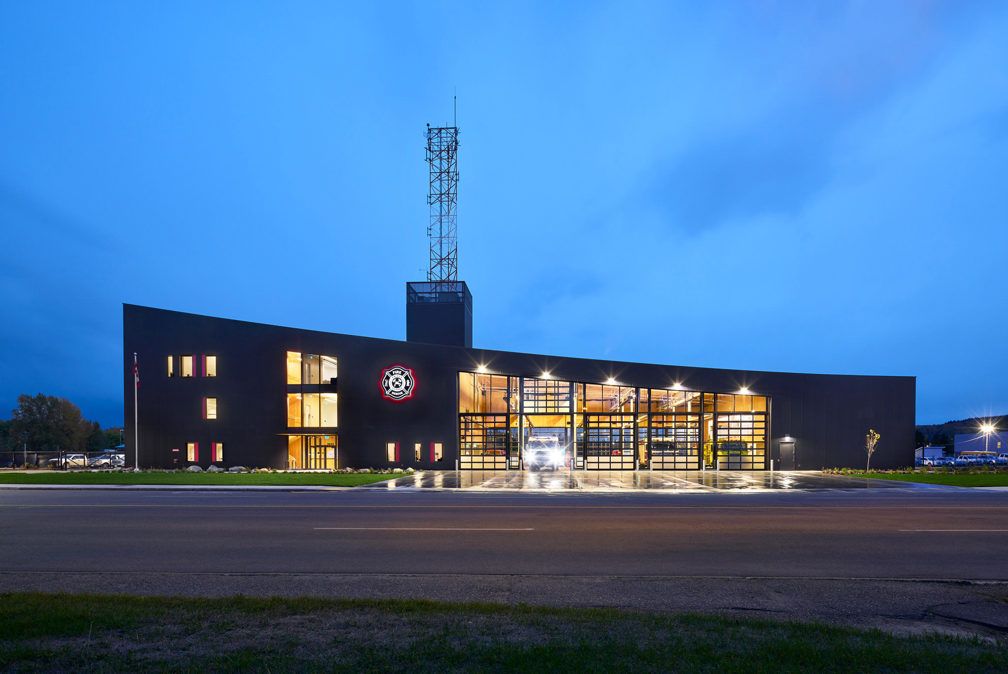Exterior Of Modern Firehall At Dusk Featuring Garage Doors